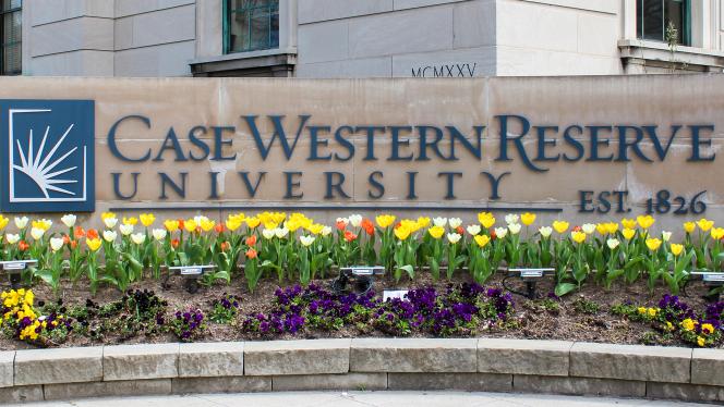CWRU Sign with tulips and purple flowers
