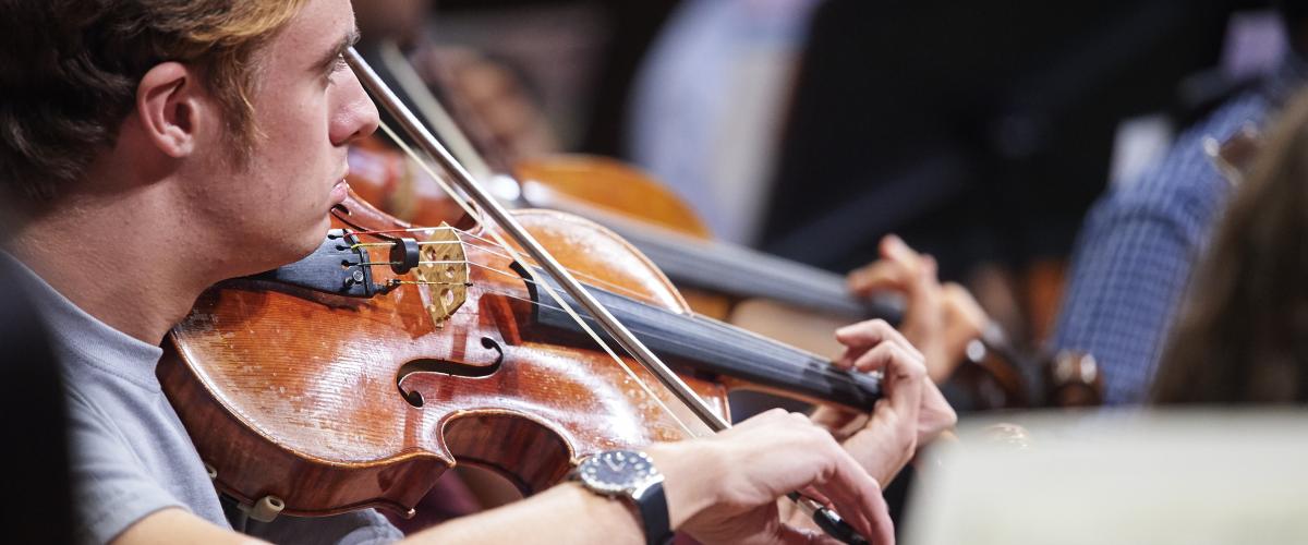 Photo of a student playing a string instrument