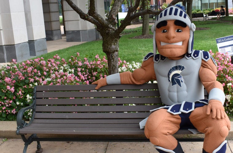 Spartie mascot sitting on a bench.