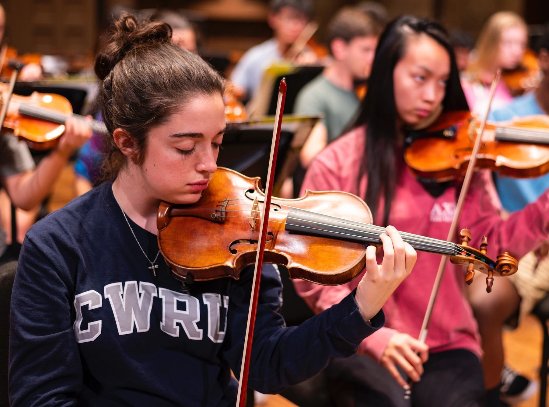 String students rehearsing with CWRU sweaters