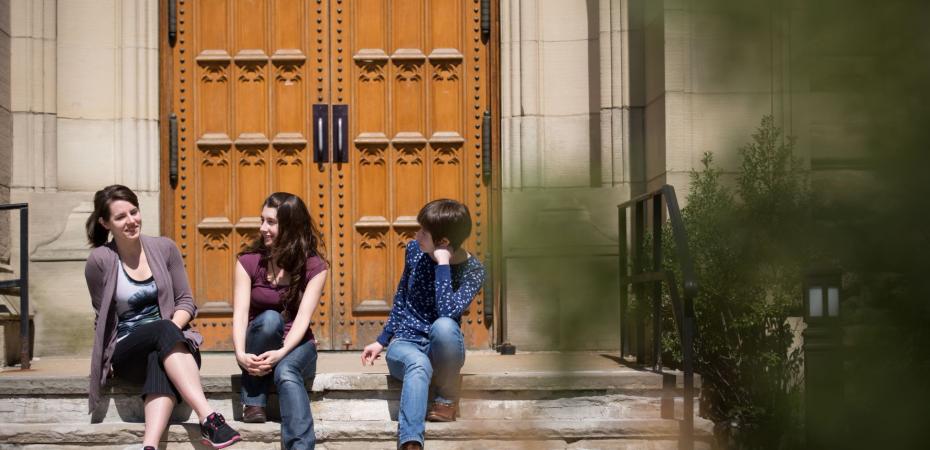 Student sitting in front of Harkness Chapel