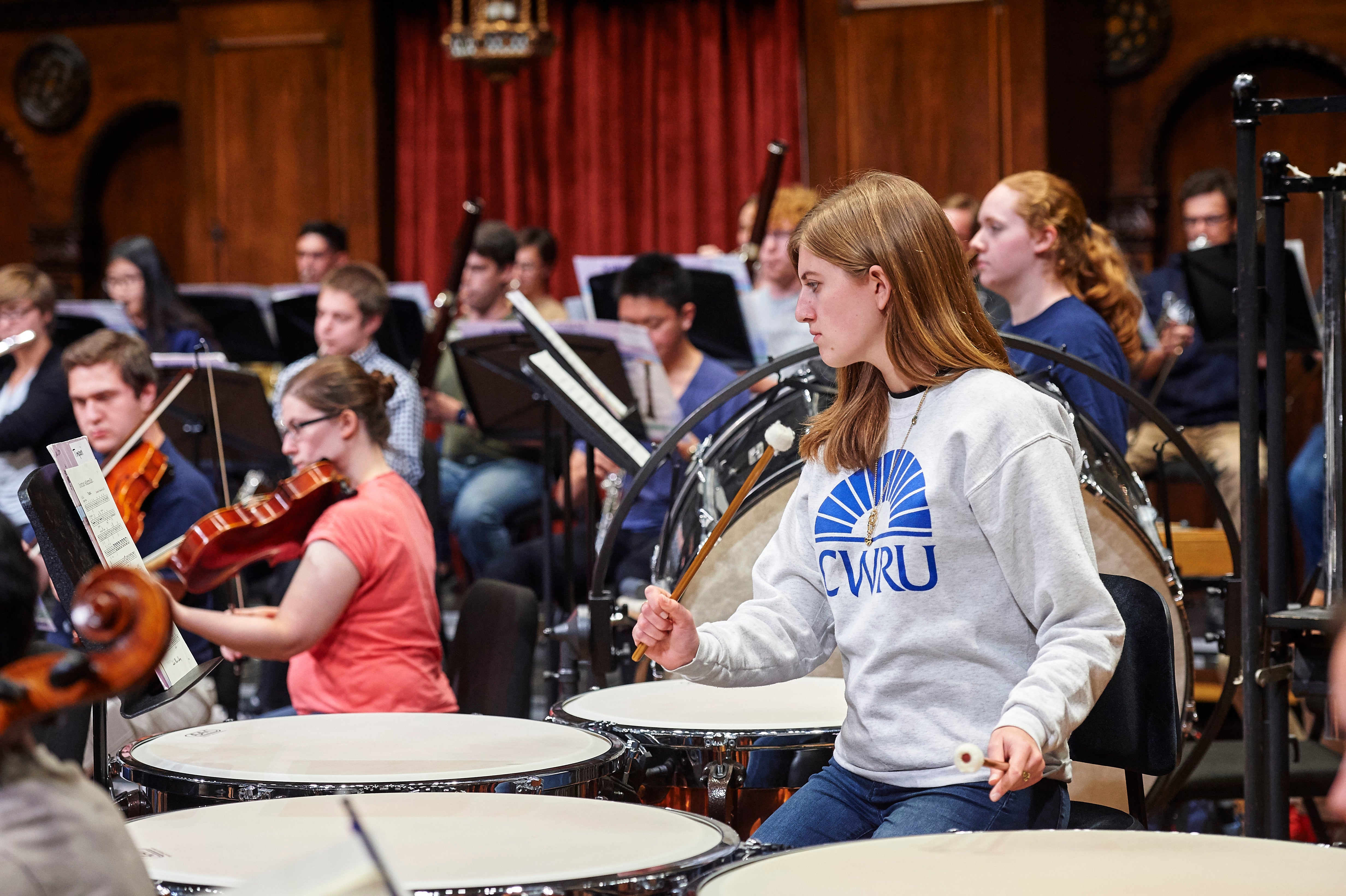 Orchestra timpani player with CWRU sweater