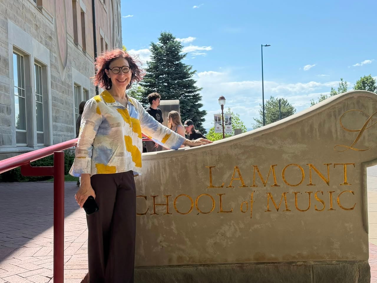Julie Andrijeski standing in front of Lamont School of Music sign
