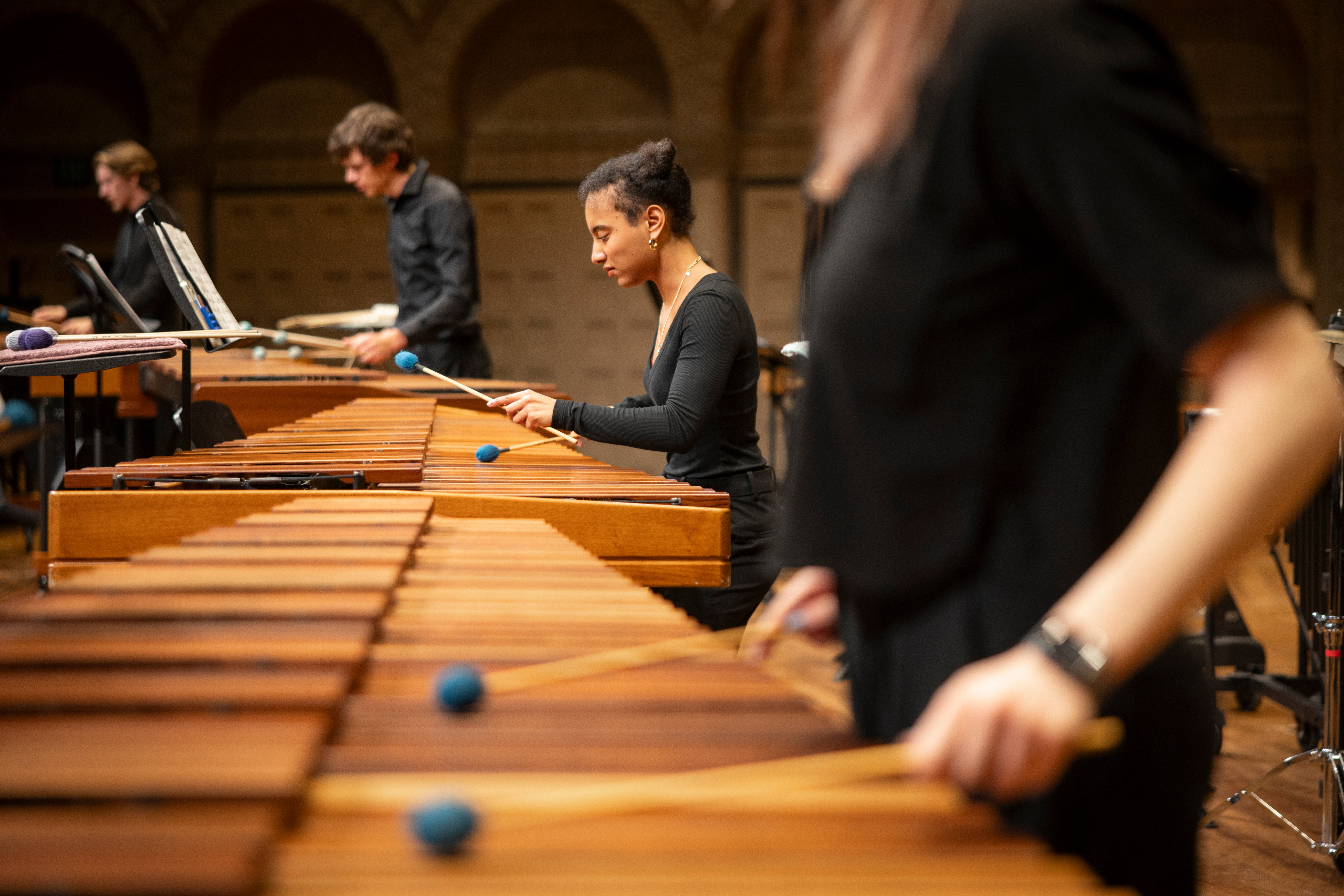 Close up of students playing marimbas.