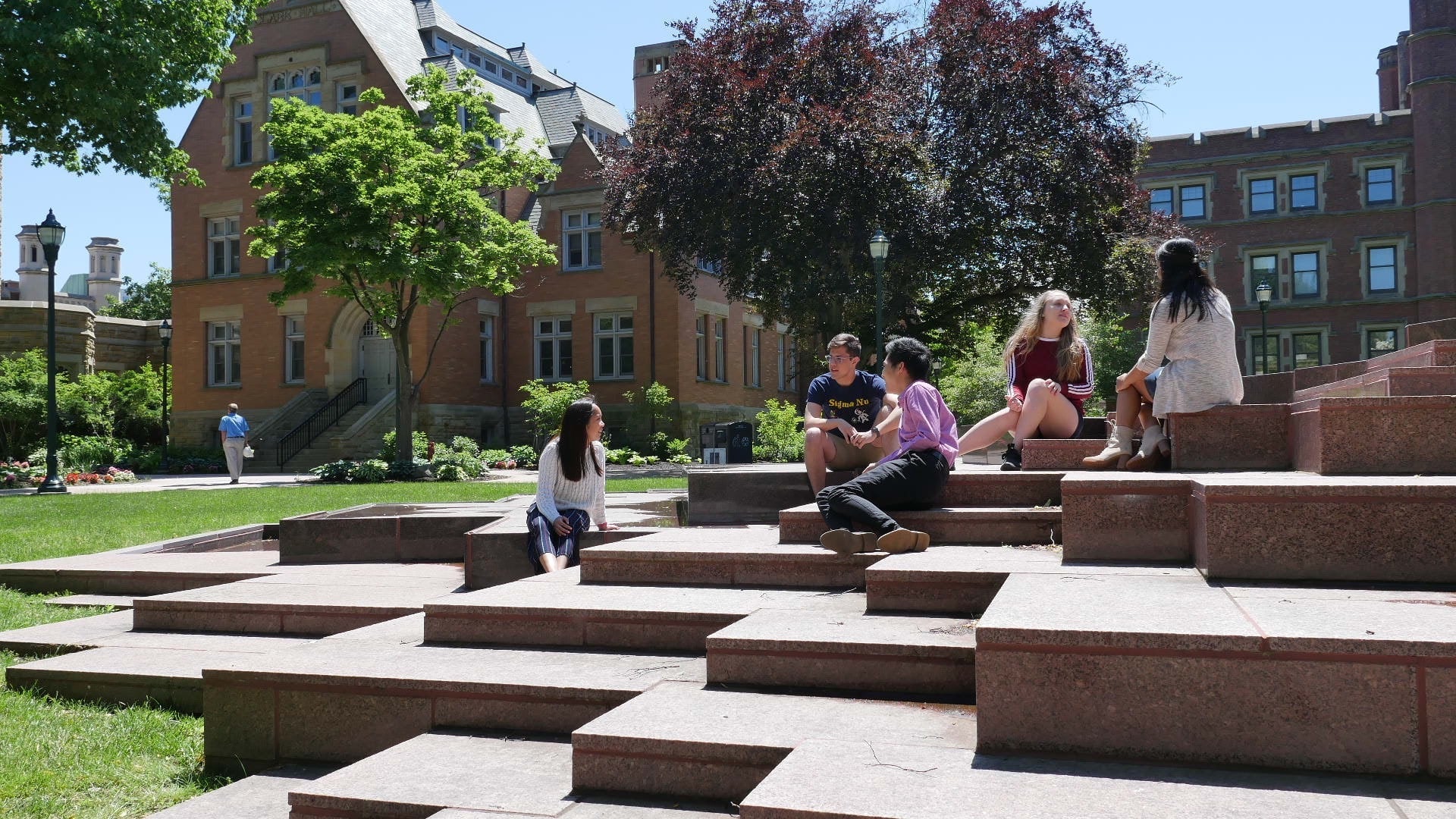 CWRU Students sitting on merging water fountain.