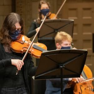 String players performing masked at the Maltz Performing Arts Center