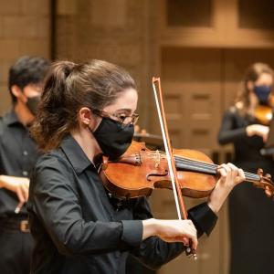 Masked string player performs at the Maltz Performing Arts Center
