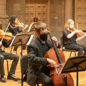 Director David Ellis performs masked with his students in the Maltz Performing Arts Center