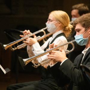Trumpet players perform masked at the Maltz Performing Arts Center