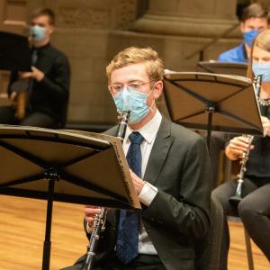 Woodwind students perform masked in the Maltz Performing Arts Center