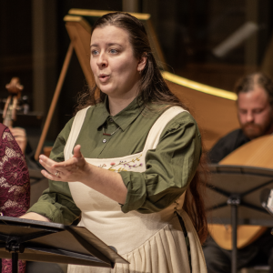 HPP vocalist gesturing and singing in MIxon Hall