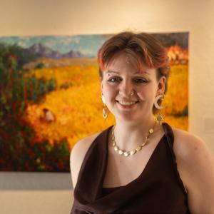 Bel Montemore photo, standing in front of painting