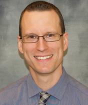 Jason Falkofsky - man smiling, with brown hair, wearing glasses