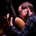 Lucas Harris playing plucked string instrument