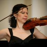 Julie Andrijeski playing baroque violin in black sparkling dress.