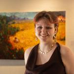 Bel Montemore photo, standing in front of painting