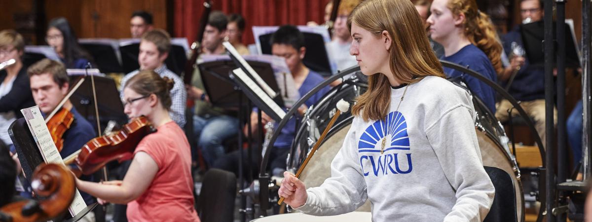 Orchestra timpani player with CWRU sweater