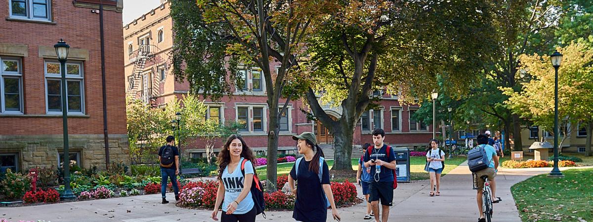 Students walking by Clark Hall and Haydn Hall.