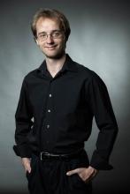 Konrad Binienda Photo - man standing in black dress shirt and pants