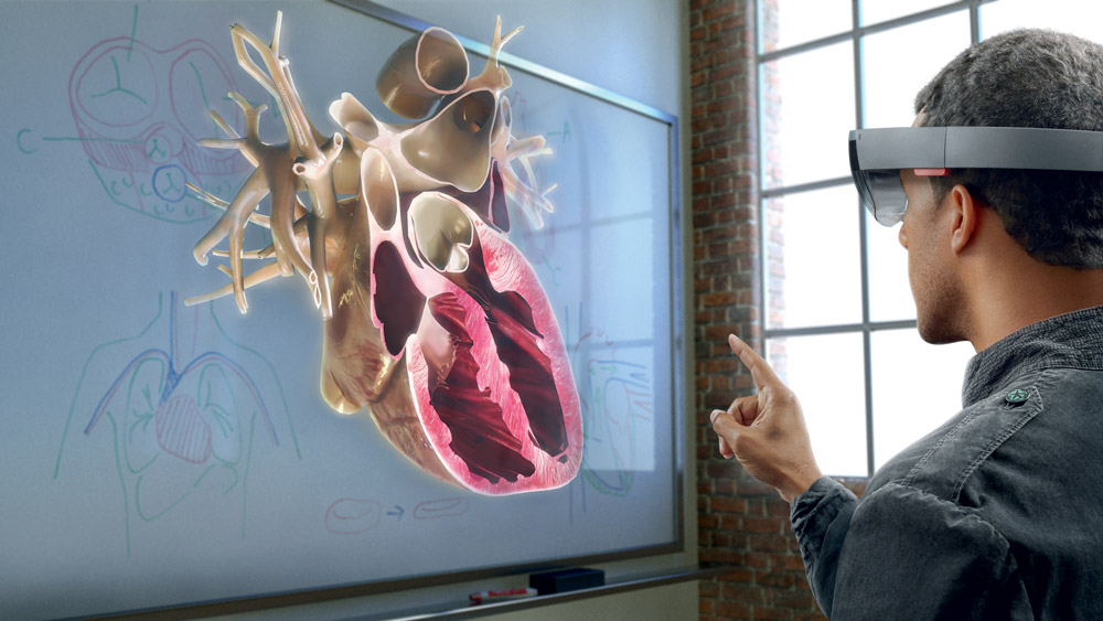 man wearing hololens interacting with a 3D heart cross-section