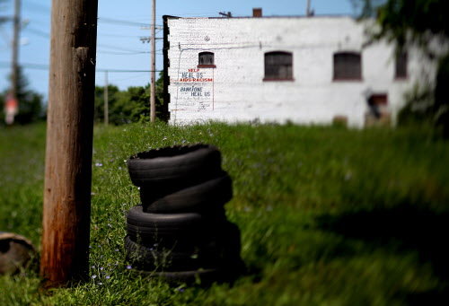 a stack of tires in the grass