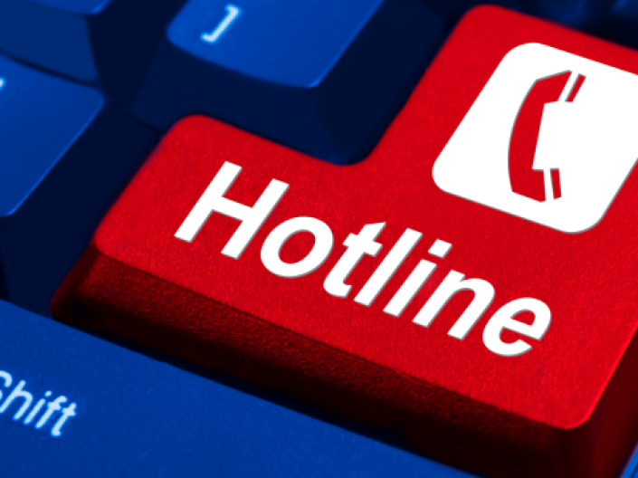The image features a white hotline telephone icon, with white lettering that display “ Hotline”. The icon is a feature of a blue computer keyboard.