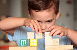 Child playing with colorful blocks