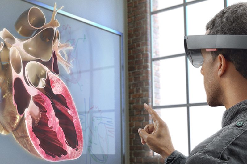 A male student using the Hololens to view the inside of a heart
