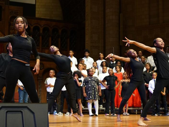 Teenage dancers perform on stage at a talent show