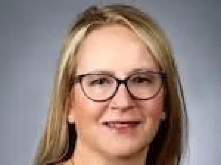 Jennifer Altstadt smiles at camera while wearing formal attire
