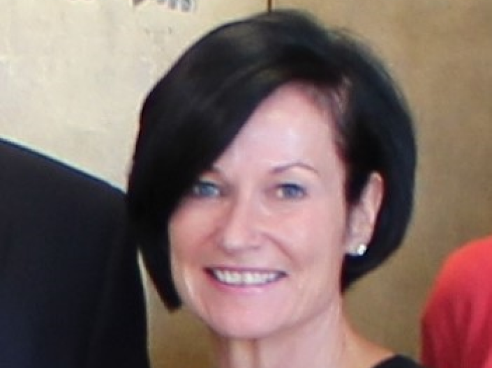 Kathleen O'Malley smiles at the camera while wearing formal attire