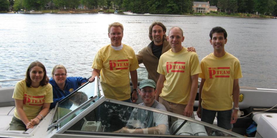 Photo of Gustafson Lab members posing on a boat
