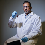 Anirban Sen Gupta holding a vial of synthetic blood