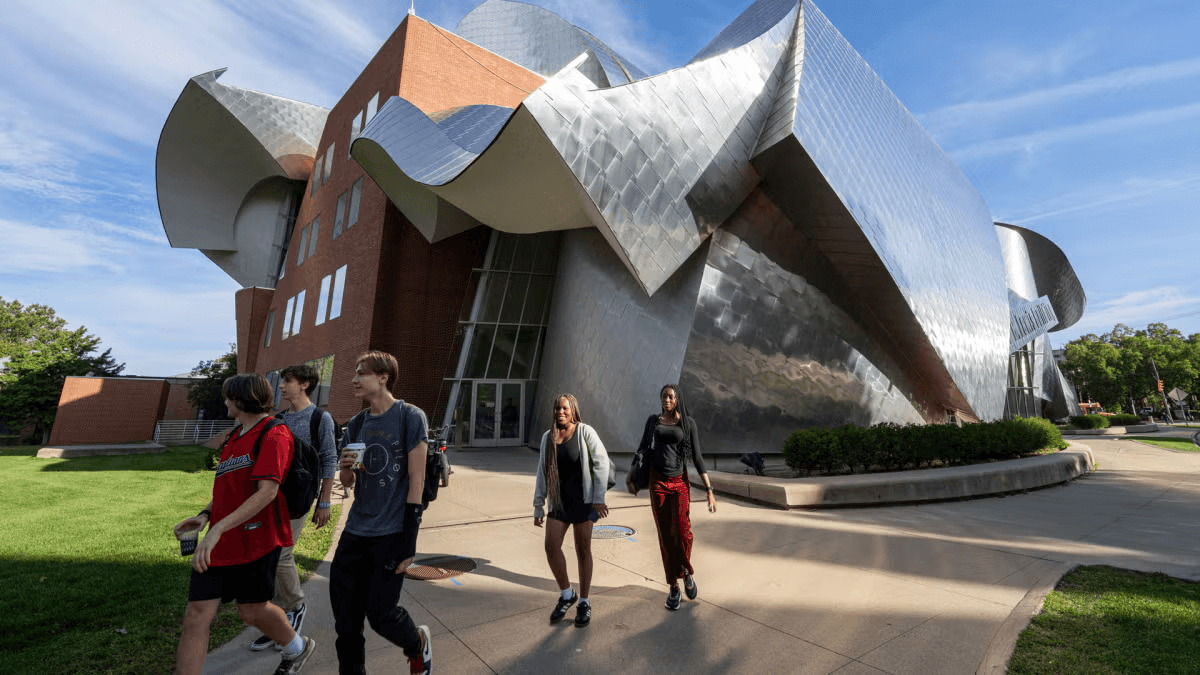 Peter B. Lewis Building with students walking on the campus lawn