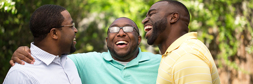 three African American men laughing together
