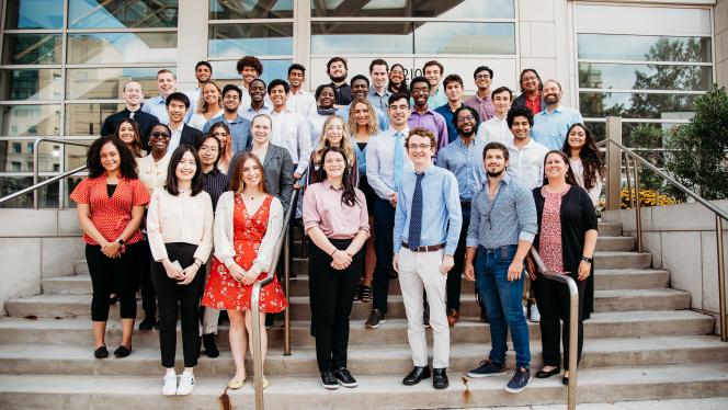 2022 CanSUR undergraduates posing and smiling on the front steps of the Wolstein Research Building