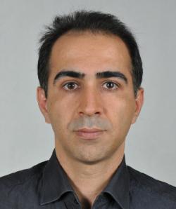 Portrait of Mehdi Alilou wearing a dark button-up shirt