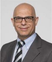 Portrait of Khalid Hassan in suit and tie