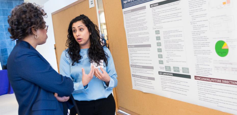 Image of an attendee presenting their research poster at the 2018 Cancer Disparities Symposium
