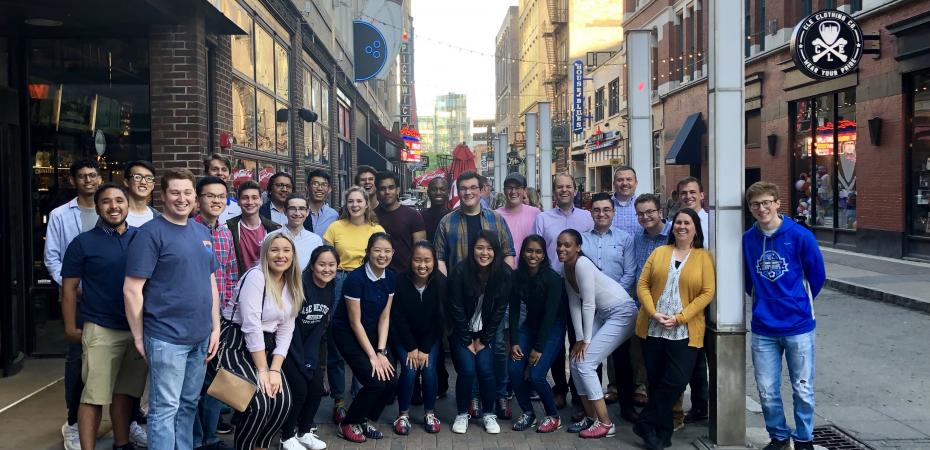 CanSUR Scholars gathered on Cleveland's East 4th street in front of Corner Alley, smiling