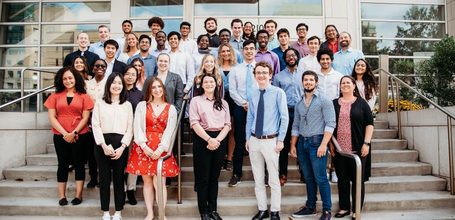 2022 CanSUR undergraduates smiling and posing on the steps outside the Wolstein Research Building
