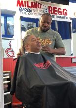 barber cutting the hair of an African American man