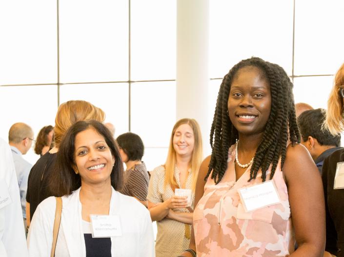 Four Annual Retreat attendees in a line, smiling