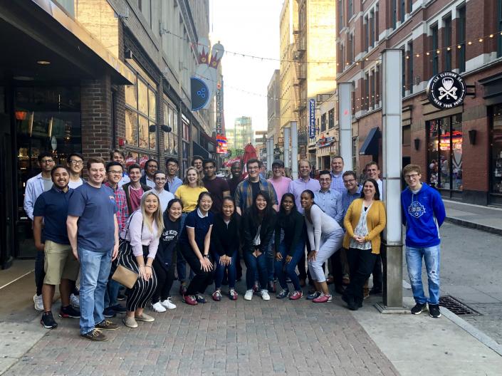 CanSUR Scholars gathered on Cleveland's East 4th street in front of Corner Alley, smiling