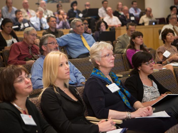 Conference attendees sitting in an auditorium