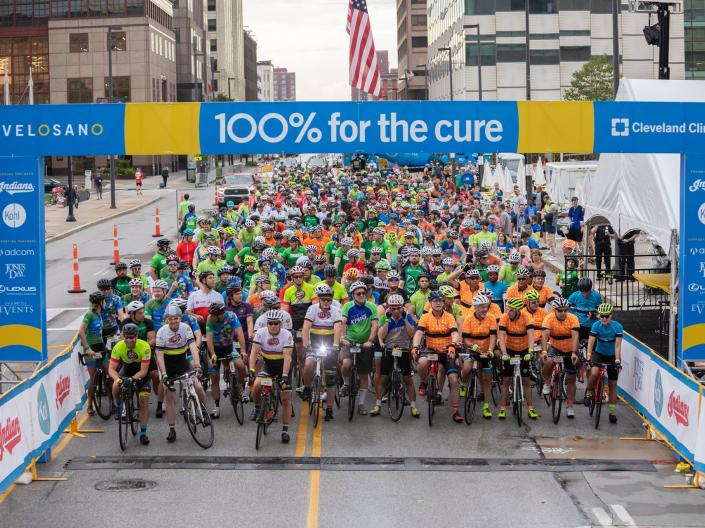 Bike riders lined up at a ride starting gate
