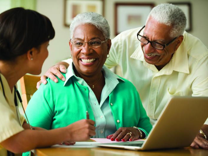African American woman and man talking to doctor