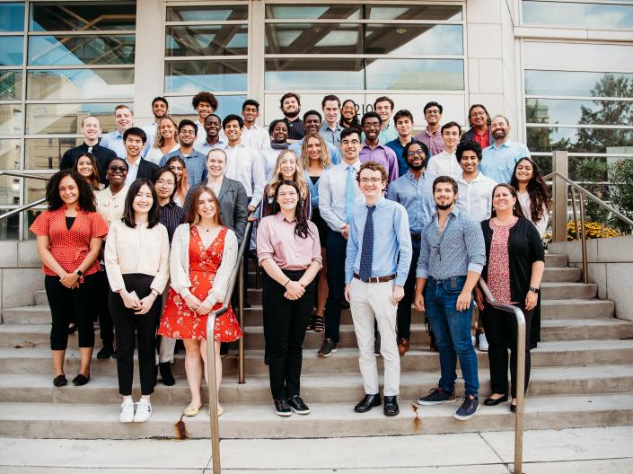 2022 CanSUR undergraduates smiling and posing on the steps outside the Wolstein Research Building