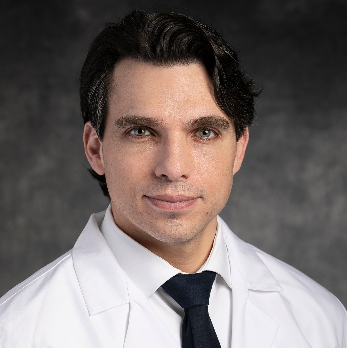 Portrait of Daniel Spratt in white coat