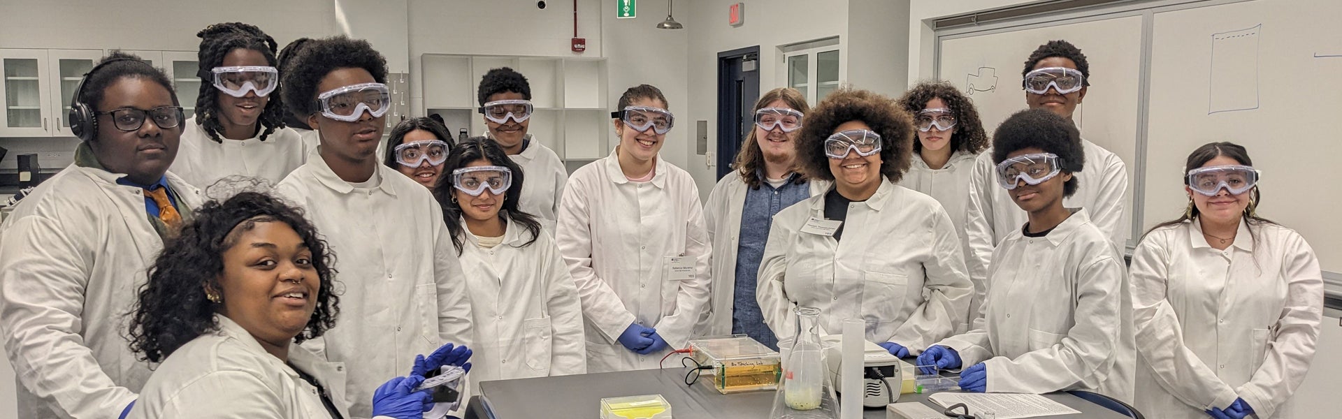 Students participating in a laboratory training experience while working together in a science classroom.